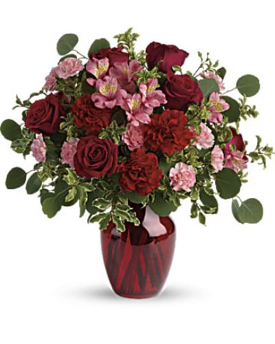 Tres belle! Ruby red roses and delicate pink alstroemeria are mixed with whimsical greens in a radiant vase for a beautifully blooming gift she'll never forget!