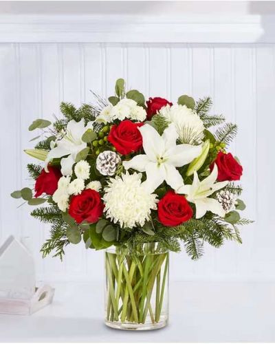 We’ve taken one of our best-selling bouquet designs and filled it with all the joyful colors and textures of the holiday season. An abundant, garden-inspired mix of blooms is gathered with glittery natural accents inside a clear glass vase. It’s a gift guaranteed to make a grand impression at every gathering.
<ul>
 	<li>All-around arrangement with red roses, white Oriental lilies, football mums and button poms, green hypericum; accented with silver dollar eucalyptus, assorted Christmas greens and glittered pinecones</li>
 	<li>Artistically designed in a clear glass vase</li>
 	<li>Extra large arrangement measures approximately 33"H x 20"W</li>
 	<li>Large arrangement measures approximately 31"H x 19"W</li>
 	<li>Medium arrangement measures approximately 28"H x 19"W</li>
 	<li>Small arrangement measures approximately 27H x 18"W</li>
 	<li>Our florists hand-design each arrangement, so colors, varieties and container may vary due to local availability</li>
 	<li>To ensure lasting beauty, Oriental lilies may arrive in bud form and will fully bloom over the next few days</li>
</ul>