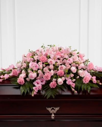 Honor a loved one who was sweet, compassionate and charming with our Garden of Comfort™ Casket Spray. It is crafted with care and composed of a refined array of pink lilies, gladiolus, roses, carnations and accents of luscious greens. This arrangement is a touching tribute that beautifully expresses your love.