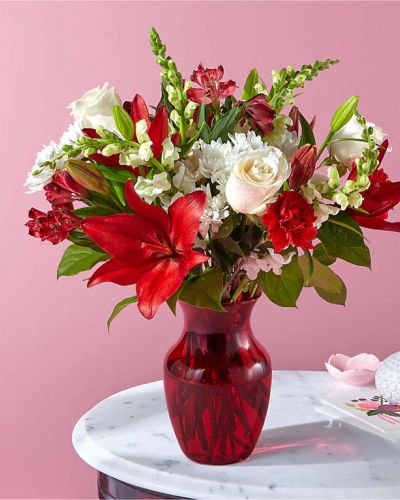 The perfect date isn't complete without classic rose blossoms, romantic white snapdragons, red carnations, and more dreamy flowers to show your affection. Please Note: The bouquet pictured reflects our original design for this product. While we always try to follow the color palette, we may replace stems to deliver the freshest bouquet possible, and we may sometimes need to use a different vase.