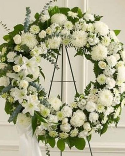 <p>The Serene Sympathies Standing Wreath is a lovely reflection of the respect, love and compassion you want to express during this difficult time. Crafted by our expert florists, this standing wreath arrangement boasts fresh white flowers such as roses, football mums, and carnations accented by spiral eucalyptus, salal and more. Appropriate for family, friends and business associates to send directly to the funeral home.</p>